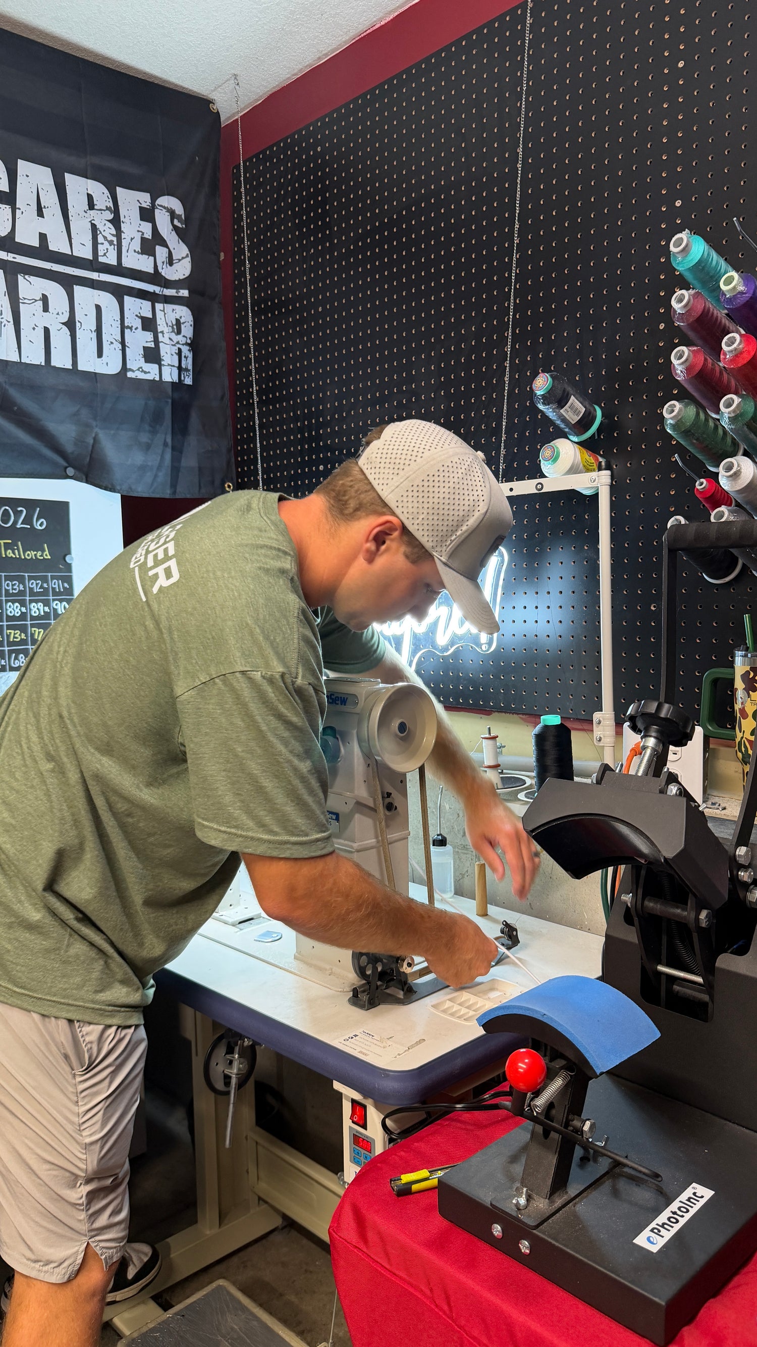 Luke_working_in_shop_wearing_green_laser_tailored_shirt_on_sewing_maching